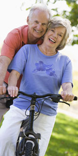 Older couple on bike in park